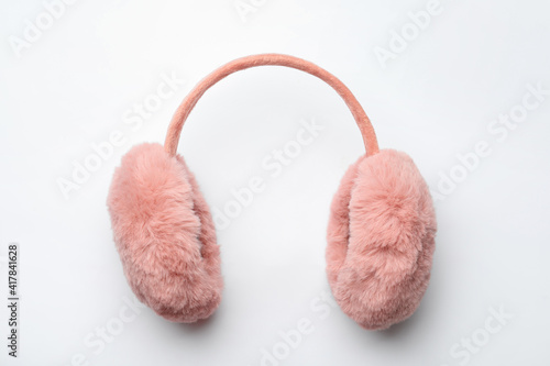 Stylish winter earmuffs on white background, top view