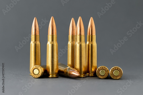 Bullets on gray background. Cartridges 7.62 caliber for Kalashnikov assault rifle closeup