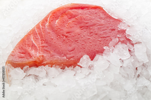 Frozen Tuna steak vacuum with ice on the counter the fishmarket. healfy food and nutrition concept