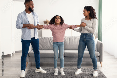 Divorce. Angry African American parents fighting over their child