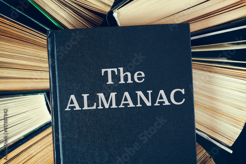 Old hardcover books with book The Almanac on top.