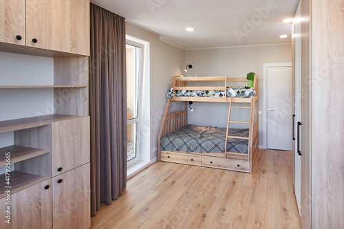 Children's bedroom in new luxury home with bunk beds and colorful comforters.