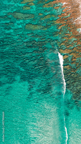 aerial drone over polihale beach showing reef