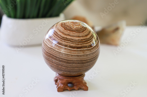 Sphere aragonite on a stand. Large ball of aragonite.