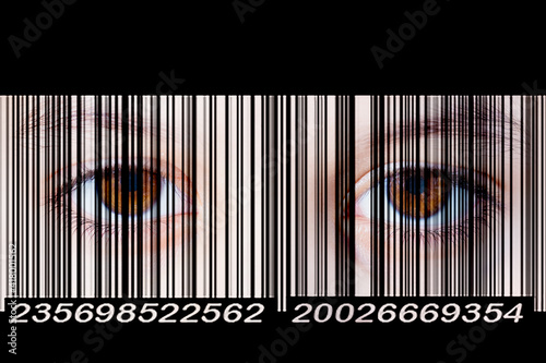 Two human eyes look through a barcode. Close-up photo. The concept of total control and identity identification.