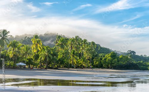 Manuel Antonio beatiful tropical beach with white sand, green palms and blue ocean. Paradise. National Park in Costa Rica, Central America.