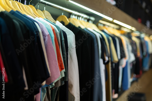Assortment of summer and autumn clothing in modern garment store interior