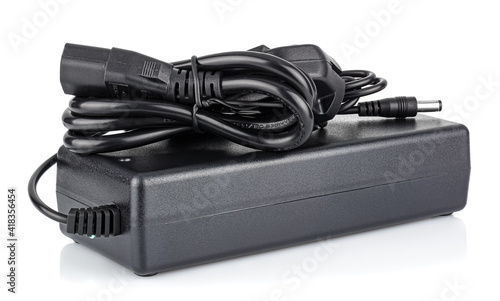 Power supply in black case with EU plug on cord isolated on white background