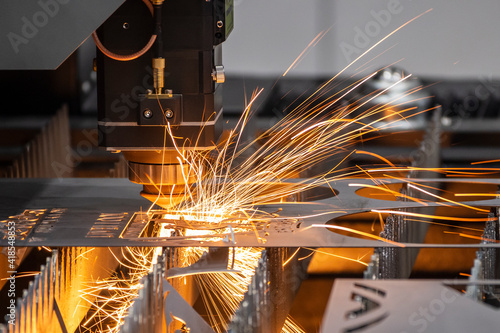 The fiber laser cutting machine cutting machine cut the metal plate. The hi-technology sheet metal manufacturing process by laser cutting machine.