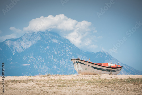 Small fishing boat on the shore with beautiful scenery