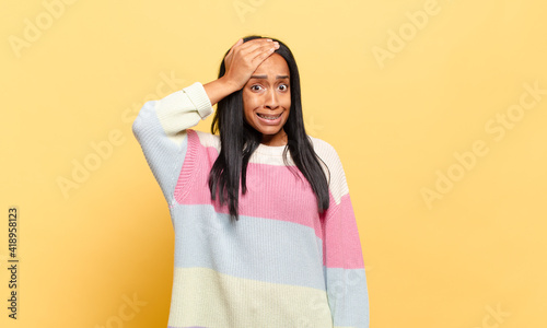 young black woman panicking over a forgotten deadline, feeling stressed, having to cover up a mess or mistake