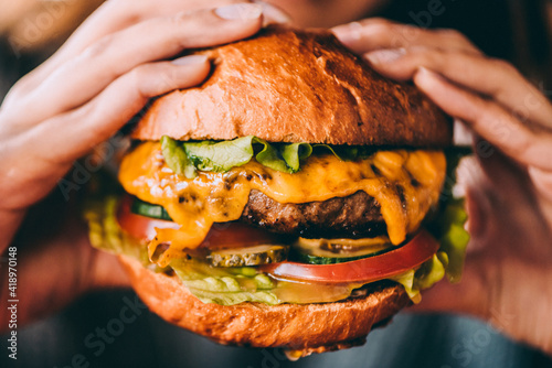 person eating cheeseburger