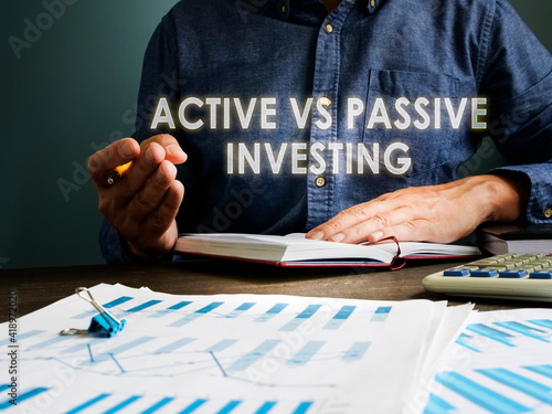 Active vs passive investing concept. The investor is sitting at the table.