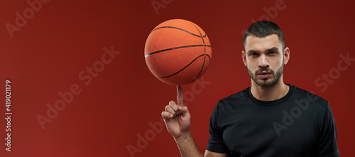 Website header of Young sportsman in black sportswear in cation on red background