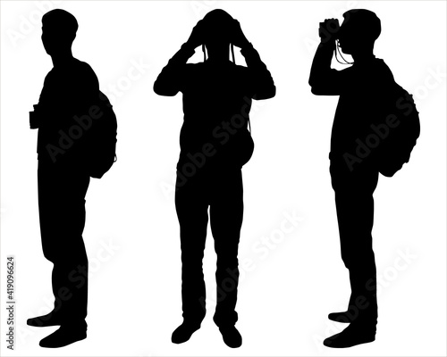 Man, boy, climber with a backpack on a back standing and looking through binoculars. Tourist, rock-climber with the binoculars in hands. Orientation to districts. Male silhouette. Side view, full face