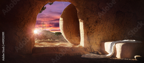 Crucifixion and Resurrection. Empty tomb of Jesus with crosses in the background. Easter or Resurrection concept. He is Risen. Happy Easter.