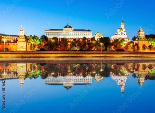 Moscow Kremlin with cathedrals, towers and palaces at sunset reflected in Moskva river, Russia