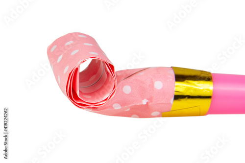 Rolled pink festive noisemaker or party whistle horn isolated on the white background