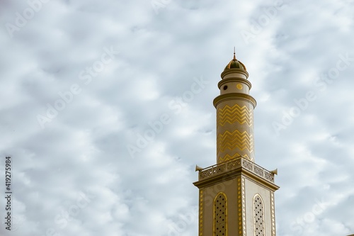 Mosque minaret with cloud sky on background. With empty space for text marhaban ya ramadan or ramadan kareem background. 