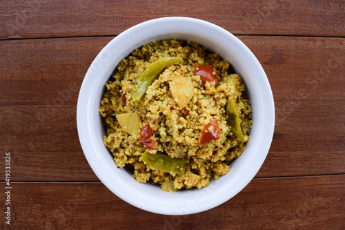 Traditional Indian fasting food recipe dish called Bhagar homemade of Barnyad millet rice grains. Also known as samo or sama pulao rice khichdi. Indian fasting food dish on wooden background