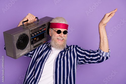 Photo of aged crazy man happy smile hold boombox excited dance isolated over violet color background