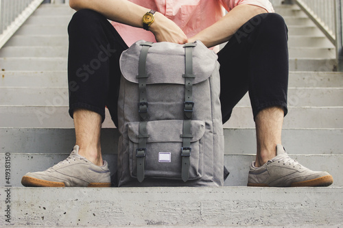 A man sitting with a backpack
