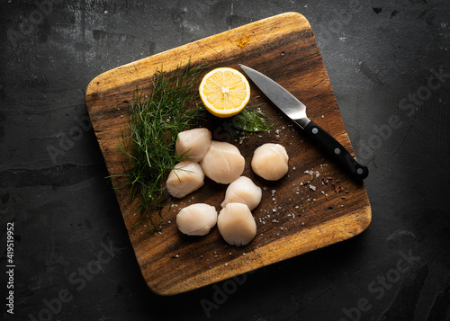 raw scallop on a wooden board 