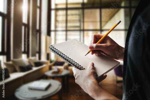 ose up of woman's hand writingis taking notes