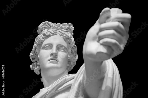 God Apollo bust sculpture. Ancient Greek god of Sun and Poetry Plaster copy of a marble statue isolated on black