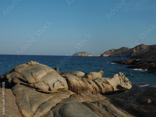 Dramatic metamorphic rock formations on coast of Serifos Island, Greece