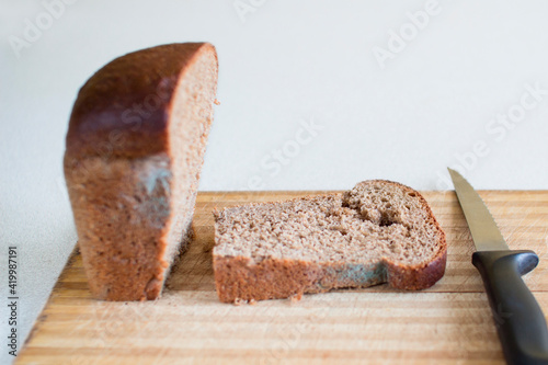 A sliced piece of stale bread with mold