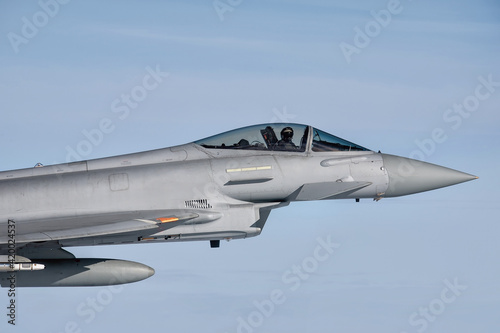 Royal Air Force Typhoon Fighter Jet. Supersonic interceptor flying in formation high above the clouds on a combat mission.