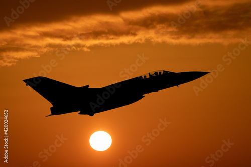 RAF Tornado Fighter jet climbing at sunset, air to air photograph of a Royal Air Force Tornado supersonic interceptor