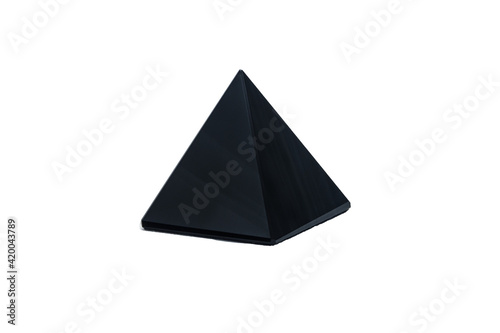 Black pyramid made of obsidian stone. Isolated on white background