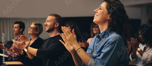 Business professionals applauding at a seminar