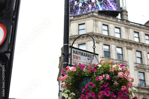 Haymarket SW1 street sign decorated with flowers