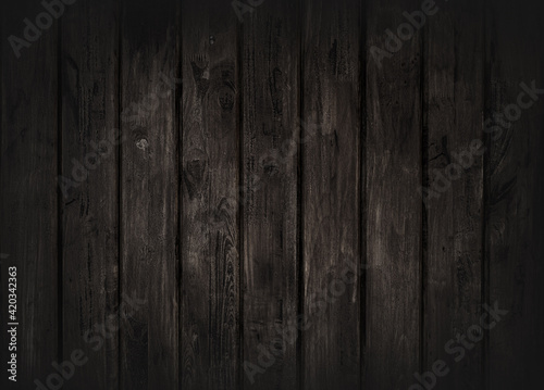 Black wood texture background coming from natural tree. The wooden panel has a beautiful dark pattern, hardwood floor texture
