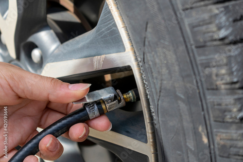 woman's hand calibrating car tire