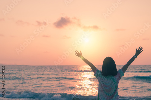 Woman rise hands up to sky travel around the world with summer beach freedom.