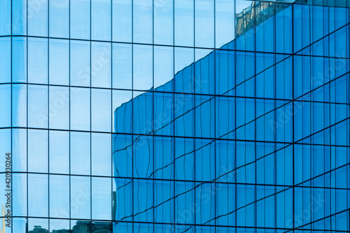 Reflection in the blue Glass Facade of a modern Office Building