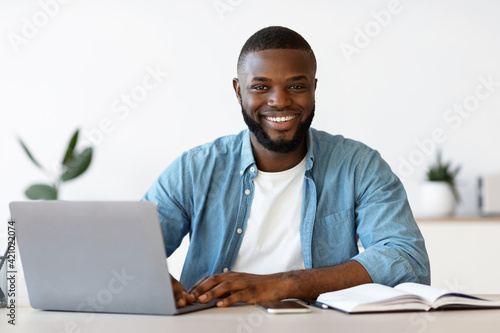 Portrait Of Smiling Successful African American Entrepreneur Posing At Workplace In Office