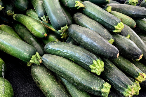 Collection of fresh, green zucchini at a market