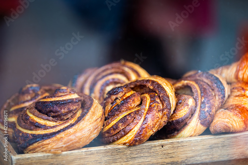 Laugavegur street in downtown with bakery cafe store shop window display of croissant, French and Danish buns cinnamon swirl rolls in Reykjavik, Iceland