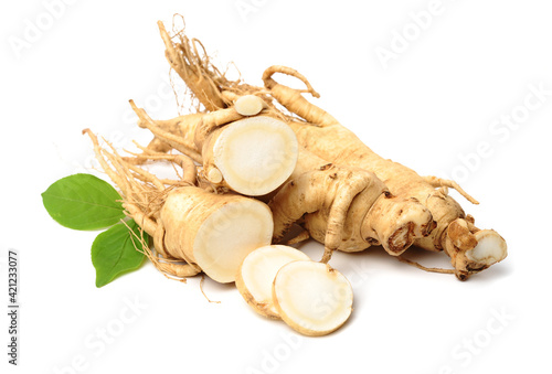 Fresh ginseng slices on white background.