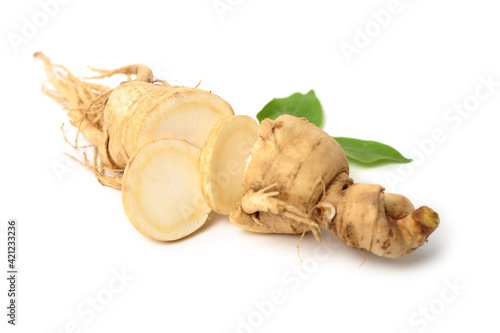 Fresh ginseng slices on white background.