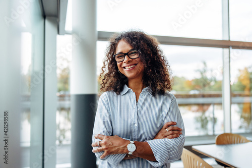 Smiling businesswoman standing in office