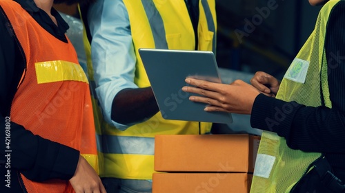 Warehouse worker working together in the storehouse . Logistics , supply chain and warehouse business concept .