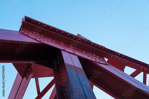 Red bascule bridge over Shadwell basin in a beautiful spring morning. Abstract graphic structure.