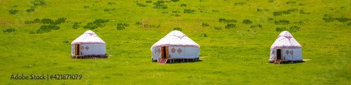 Yurt. National ancient house of the peoples of Kazakhstan and Asian countries. National Housing. Yurts on the background of a green meadow and highlands.