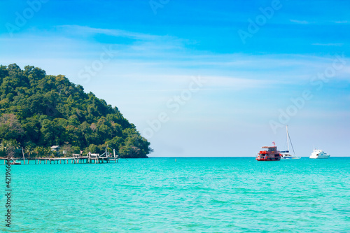 Koh Kood island is emerald green sea in the clear blue sky during the day time.